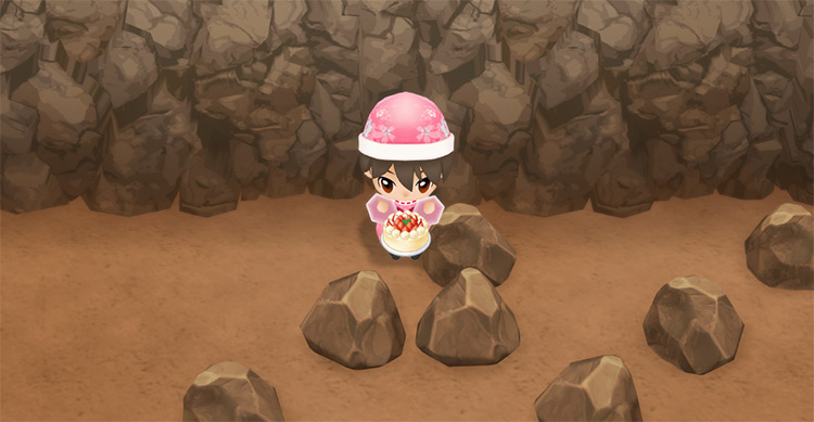 The farmer eats a serving of Strawberry Cake to restore stamina while mining. / Story of Seasons: Friends of Mineral Town