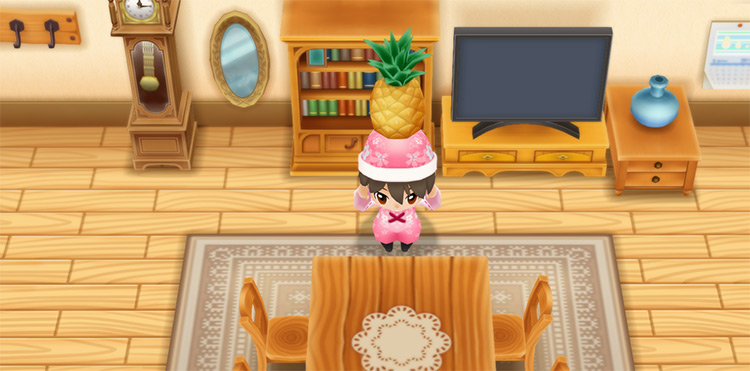 The farmer holds up a Pineapple in front of the dining table. / Story of Seasons: Friends of Mineral Town