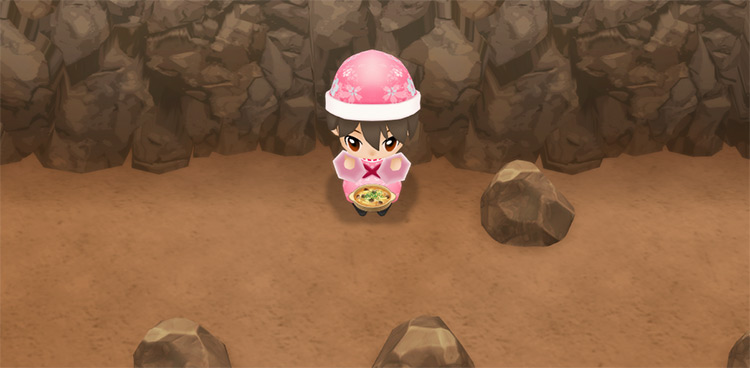 The farmer eats a serving of Mushroom Gratin to restore stamina while mining. / Story of Seasons: Friends of Mineral Town
