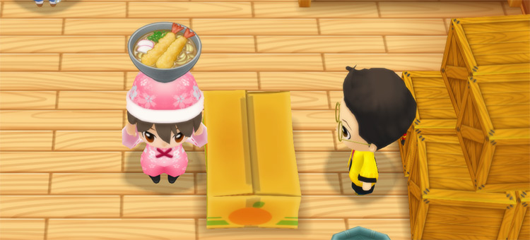 The farmer stands in front of Huang’s counter while holding a bowl of Tempura Udon. / Story of Seasons: Friends of Mineral Town