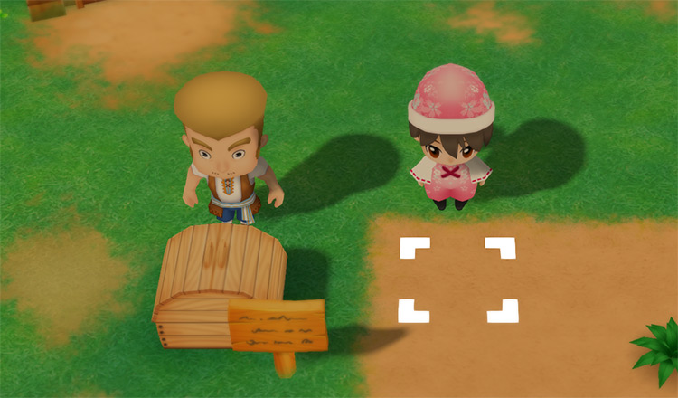 Zack stands behind the Shipping Bin on the farm. / Story of Seasons: Friends of Mineral Town