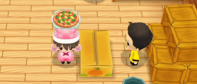 The farmer stands in front of Huang’s counter while holding a Vegetable Pizza. / Story of Seasons: Friends of Mineral Town