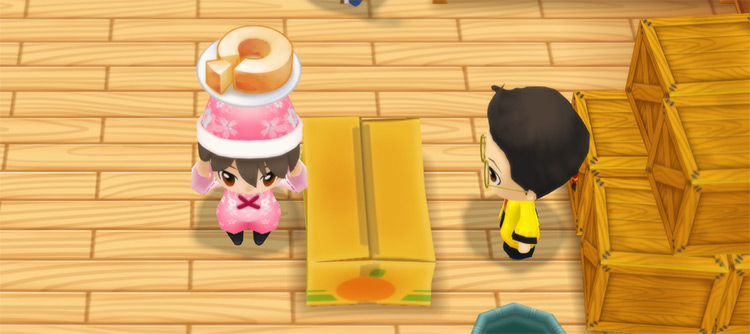 The farmer stands in front of Huang’s counter while holding a plate of Baumkuchen. / Story of Seasons: Friends of Mineral Town