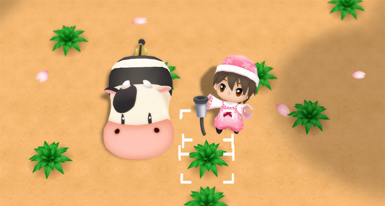 The farmer equips the milker next to a cow. / Story of Seasons: Friends of Mineral Town