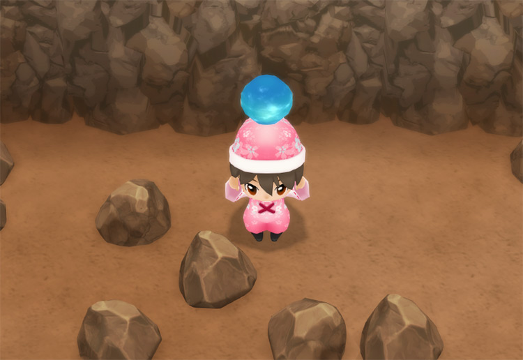 Holding a Goddess Jewel inside the Spring Mine. / Story of Seasons: Friends of Mineral Town