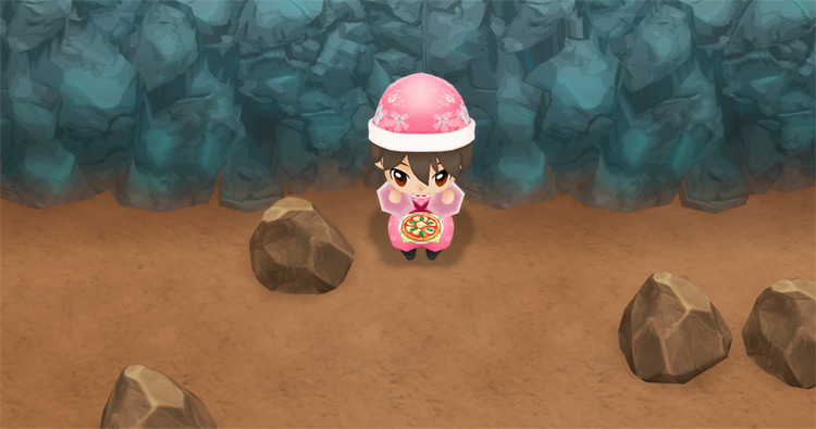 The farmer eats a pan of Margherita to restore stamina while mining. / Story of Seasons: Friends of Mineral Town