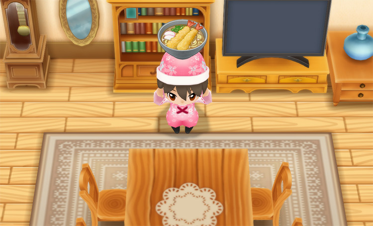 The farmer holds a bowl of Tempura Udon in front of the Dining Table. / Story of Seasons: Friends of Mineral Town