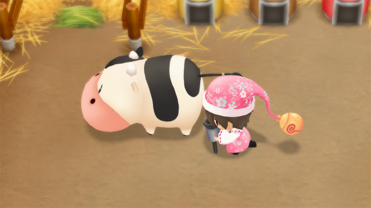 The farmer harvests Milk from a cow using the Milker. / Story of Seasons: Friends of Mineral Town