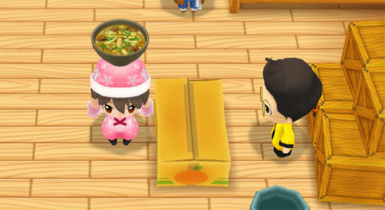 The farmer stands in front of Huang’s counter while holding a bowl of Curry Udon. / Story of Seasons: Friends of Mineral Town
